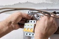 Electrical work to install new panel of electric distribution board consumer unit with fuse box or circuit breaker Royalty Free Stock Photo