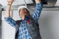 Electrical worker wiring in ceiling Royalty Free Stock Photo