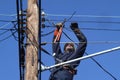 Electrical worker working on electrical lines on the pole