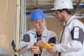 Electrician with apprentice working in new home Royalty Free Stock Photo