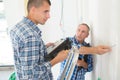 Electrician with apprentice working in new home Royalty Free Stock Photo