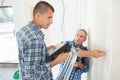 Electrician with apprentice working in new home Royalty Free Stock Photo
