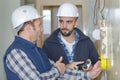 electrician with apprentice working in new home Royalty Free Stock Photo