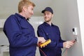 electrician with apprentice working in new home Royalty Free Stock Photo
