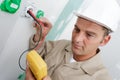 Electrician assembles standard bipolar wall socket Royalty Free Stock Photo