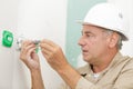 Electrician assembles standard bipolar wall socket Royalty Free Stock Photo