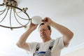 Electrician is attaching a plafond.