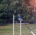 The electrician changes the lamp on the light pole, the car-tower lifts the worker to the pole to replace the light bulb