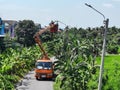 Electrician changing lamps on poles, Nonthaburi, Thailand, 27 May 2021.