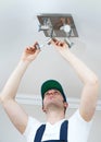 Electrician changing the light bulb. Royalty Free Stock Photo
