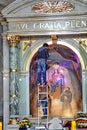 Electrician changing lights in a church altar