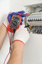 Electrician check voltage in electrical fuse box. Royalty Free Stock Photo