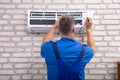 Electrician Checking Air Conditioner