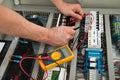 Electrician checking a fuse box