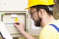 Electrician checking fuse box Royalty Free Stock Photo