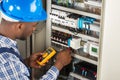 Electrician Checking Fuse Box With Multimeter Royalty Free Stock Photo