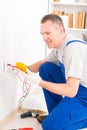 Electrician checking socket Royalty Free Stock Photo