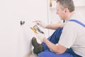 Electrician checking socket Royalty Free Stock Photo