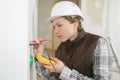 electrician checking socket voltage using multimeter Royalty Free Stock Photo