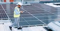 Electrician checking solar panels technology on the roof of the building his working on. Professional engineer Royalty Free Stock Photo