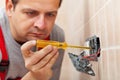 Electrician checking wall fixture with voltage tester Royalty Free Stock Photo