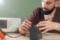 Electrician checks the battery in the laboratory Royalty Free Stock Photo