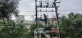 Electrician climbed up and fixing the problem in high voltage transformer without proper safety gears