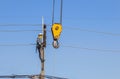 Electrician climbing work in the height on concrete electric power pole with big crane
