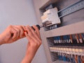 The electrician is connecting the electric cable wire. Engineer maintenance the system control Royalty Free Stock Photo