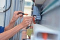 The electrician is connecting the electric cable wire Royalty Free Stock Photo