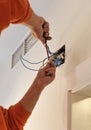 Electrician connecting the wiring during the renovation of the house Royalty Free Stock Photo