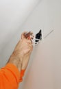 Electrician connecting the wiring during the renovation of the house Royalty Free Stock Photo