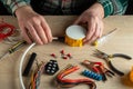 The electrician connects the cable to the junction box. Close-up of the hand of the master