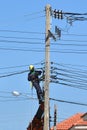 Electrician connects wires on a pole