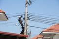 Electrician connects wires on a pole