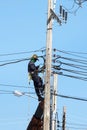 Electrician connects wires on a pole