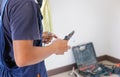 Electrician cuts electrical wires with pliers, Technician installing air conditioning in a client house, Repairman fixing air Royalty Free Stock Photo