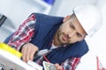 Electrician cutting red cable with cutters