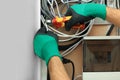 Electrician cutting wires in fuse box, closeup Royalty Free Stock Photo