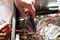 Electrician dismantles electric oven during repair