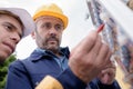 Electrician engineer checking data from control panel holding tablet computer Royalty Free Stock Photo