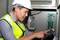 Electrician engineer touch the tablet and find the information how to operate the generator