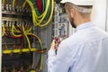 Electrician engineer at work inspecting cabling connection of high voltage power electric line