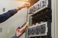 Electrician engineer work  tester measuring  voltage and current of power electric line. Royalty Free Stock Photo