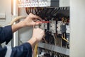 Electrician engineer work tester measuring voltage and current of power electric line in electrical cabinet control , concept chec Royalty Free Stock Photo