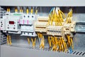 Electrician engineer work tester measuring voltage and current of power electric line in electical cabinet control.and