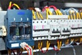 Electrician engineer work tester measuring voltage and current of power electric line in electical cabinet control.and