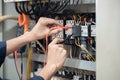 Electrician engineer work tester measuring voltage and current of power electric line in electrical cabinet control , concept chec Royalty Free Stock Photo