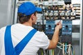 electrician engineer worker checks electrical equipment for repair Royalty Free Stock Photo