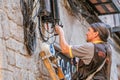 electrician engineer works with cables in electric network at city street